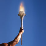 Athlete’s arm holding up a torch